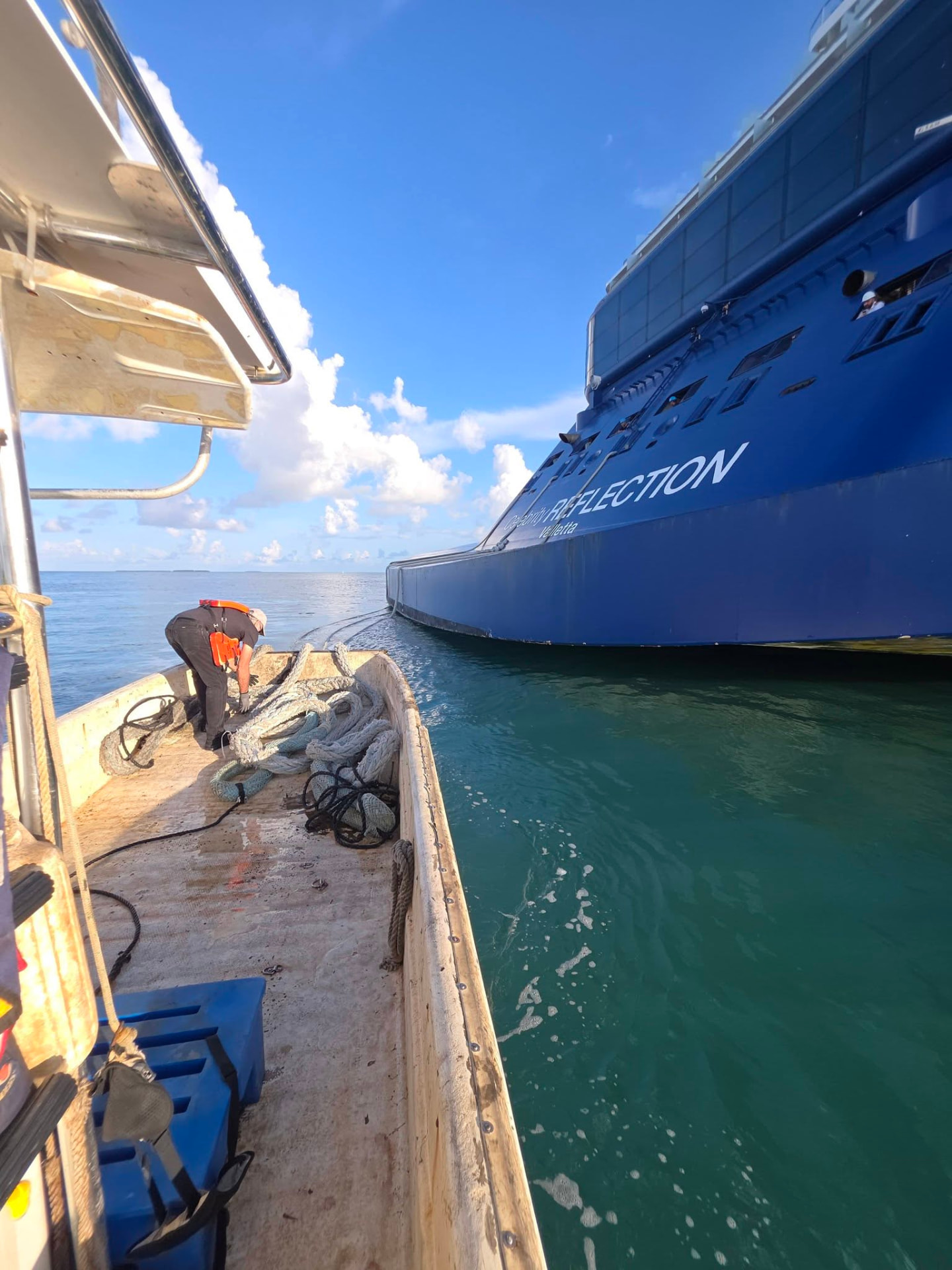 Keys Watermen boat making a delivery alongside a ship near Key West
